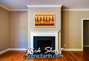 western art on display over a fireplace in a living room