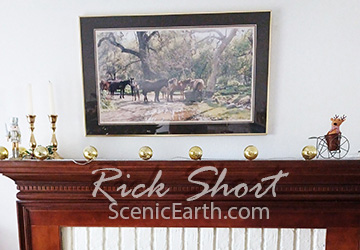 western art on display over a fireplace in a living room